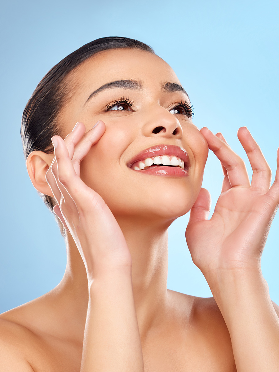 Young woman with nice skin touching her face