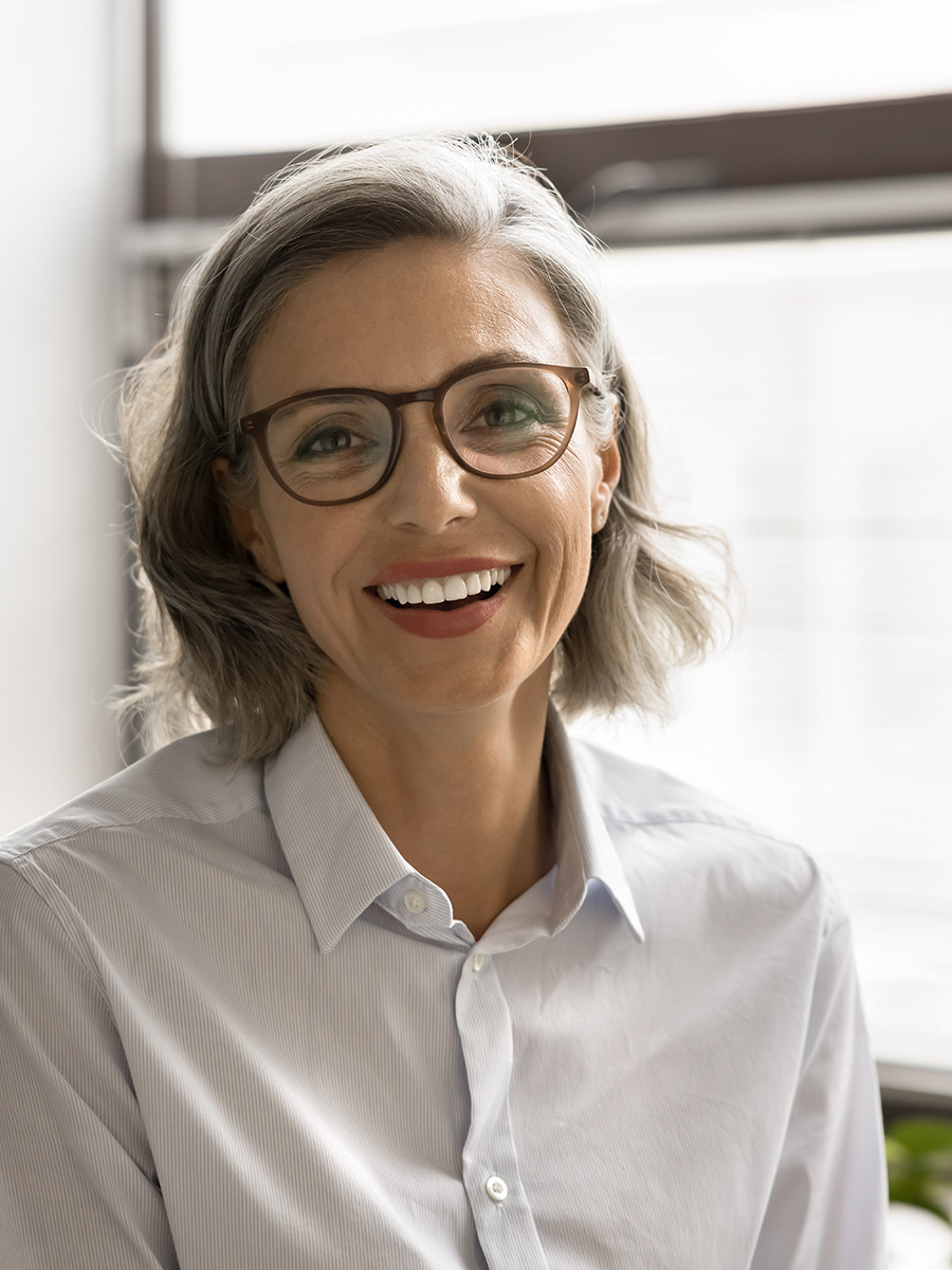 Mature woman with glasses smiling