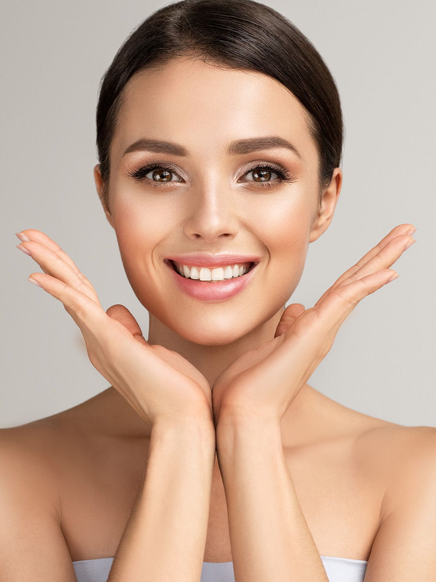 Young woman with her hands under her chin