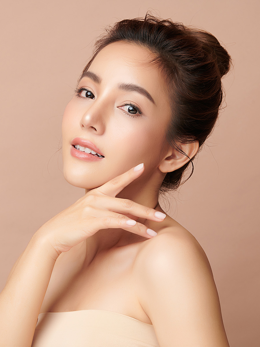 Young woman touching her face