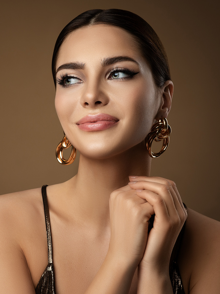 Beautiful woman with gold earrings
