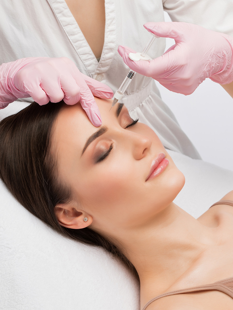 Woman getting an injection on her face