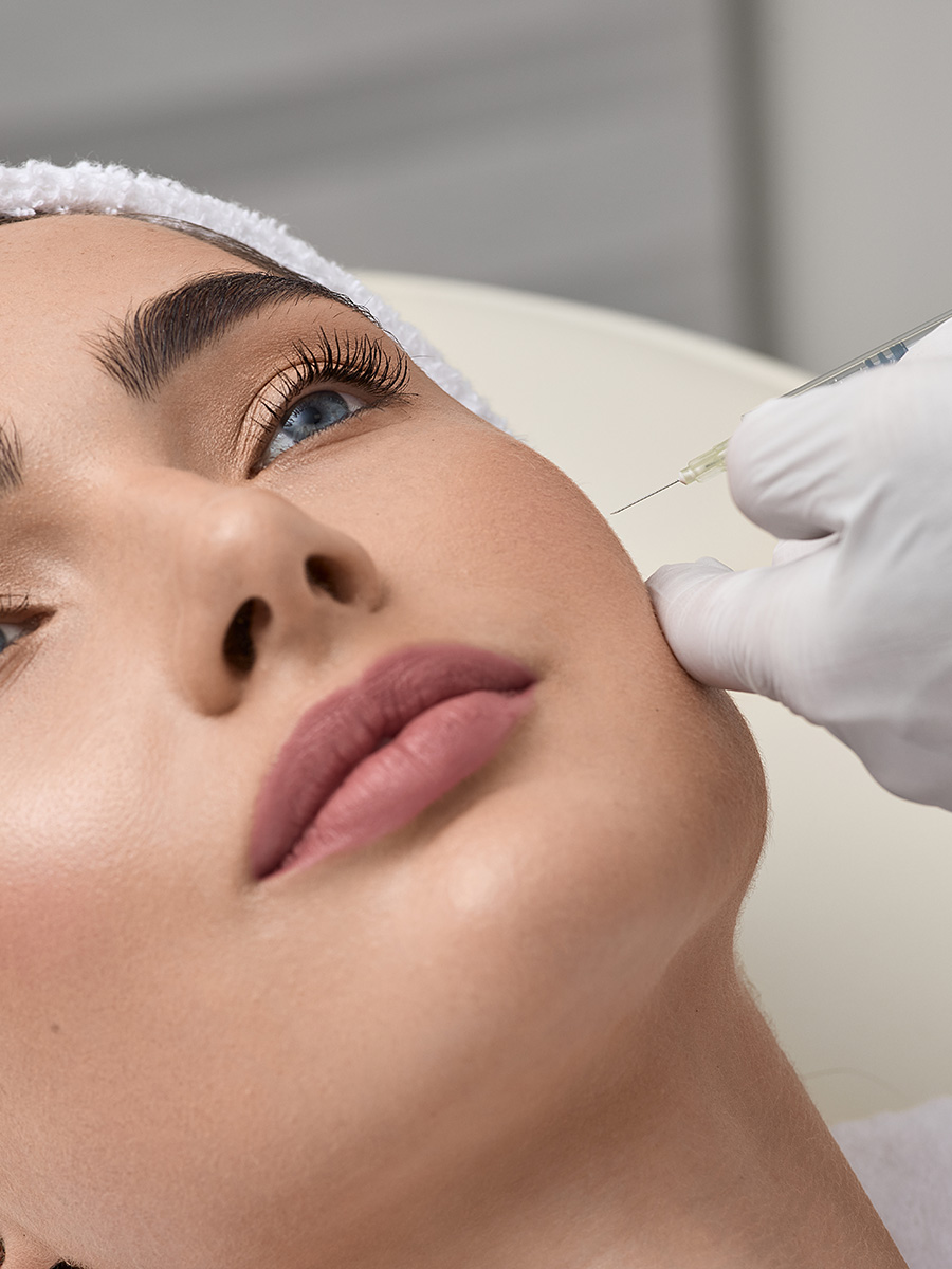 A woman getting an injection on her face