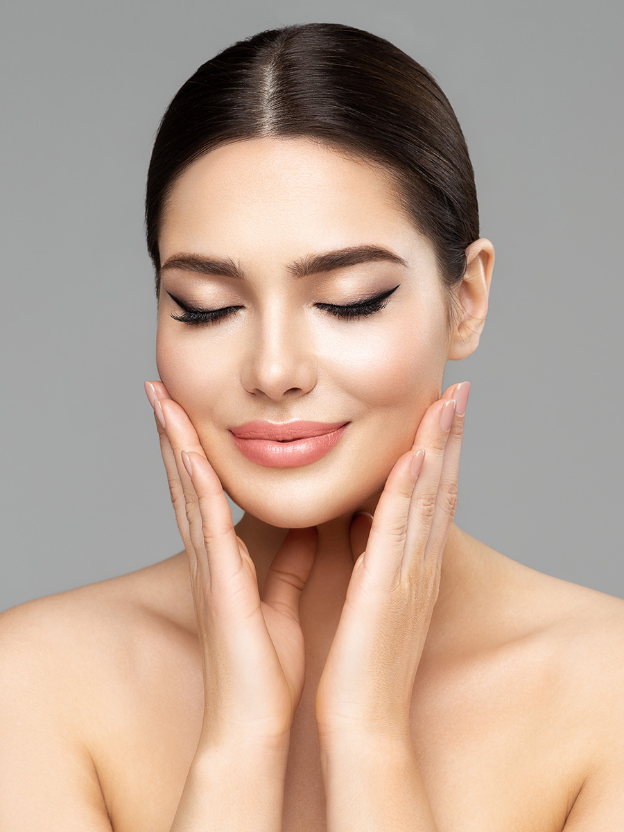 Young woman with nice skin touching her face
