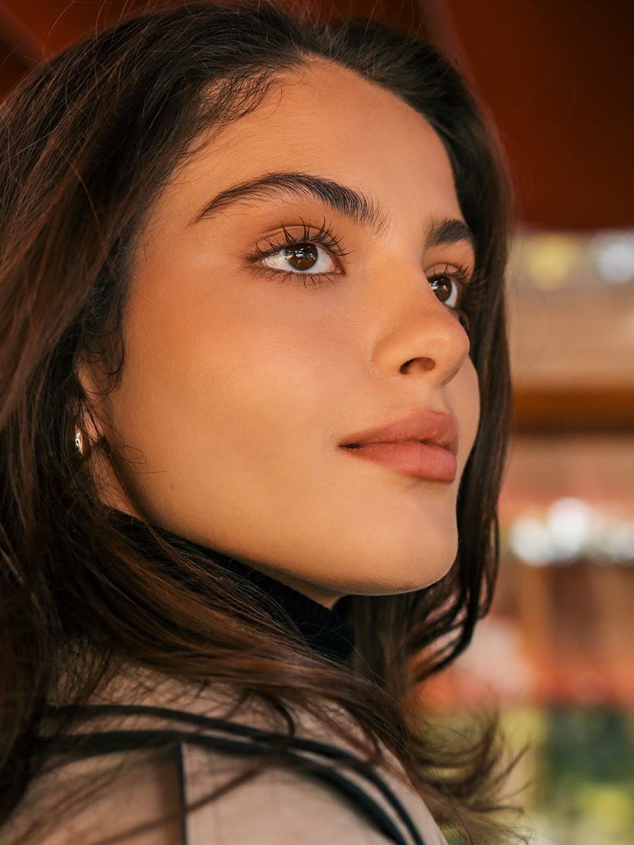 Woman with long eyelashes smirking