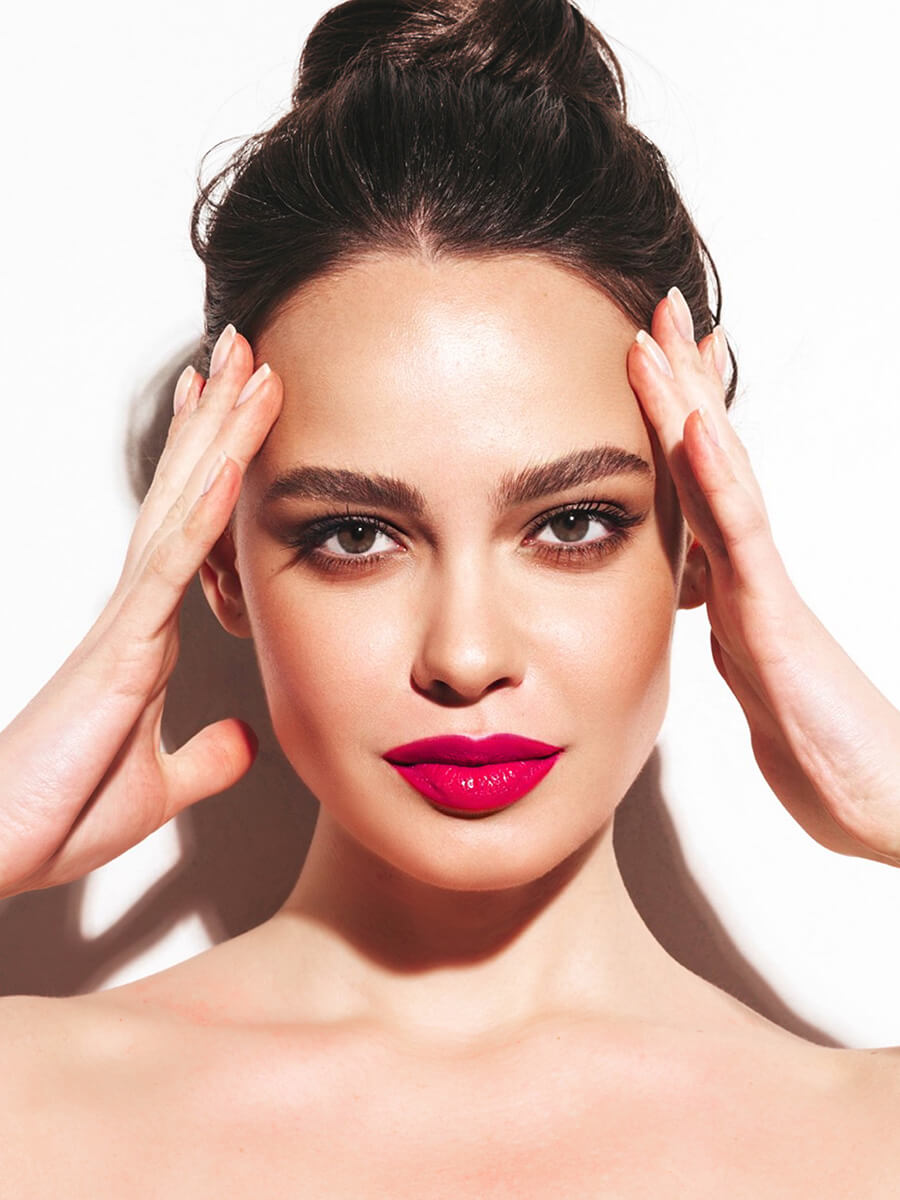 Woman with red lipstick touching her forehead